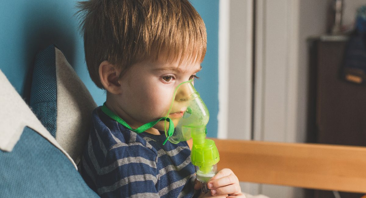image of a 4-5 year old pediatric patient with a nebulizer mask